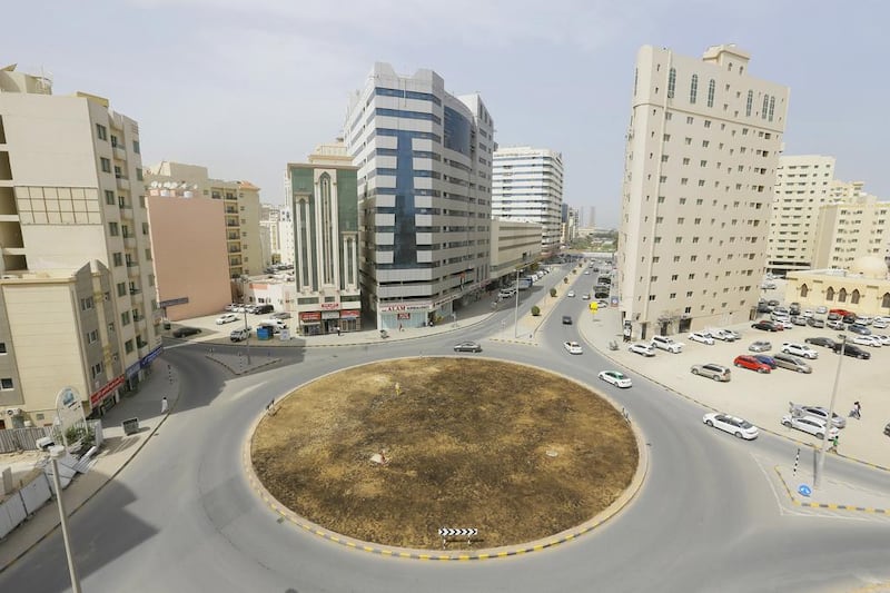 Seeds planted by Pakistani municipal gardeners on this roundabout in Al Nabaah, Sharjah, will grow into  crops, in Vikram Divecha’s Beej project for the Sharjah Biennial 13. Jeffrey E Biteng / The National.