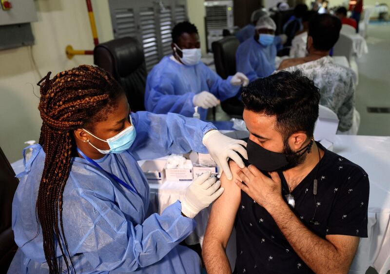 The Chinese Sinopharm coronavirus vaccine is given to a man at the Guru Nanak Darbar gurudwara (Sikh temple) in Dubai. Organisers said all slots for the vaccines were quickly booked. Karim Sahib / AFP