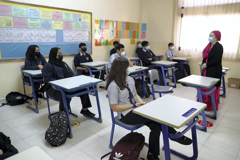 SHARJAH, UNITED ARAB EMIRATES , September 28 – 2020 :- Diana Parva , French teacher taking the class of grade 11 on the first day of the school after reopening at the Victoria English School in Sharjah. New Covid safety setup placed in different areas of the school such as hand sanitizer, safety message, social distancing stickers pasted on the floor, disinfection tunnels installed at all the gates of the school. (Pawan Singh / The National) For News. Story by Salam
