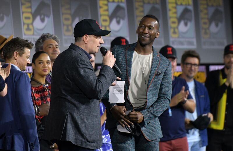 President of Marvel studios Kevin Feige (C) welcomes US actor Mahershala Ali on stage during the Marvel panel in Hall H of the Convention Center during Comic Con in San Diego, California on July 20, 2019. / AFP / Chris Delmas
