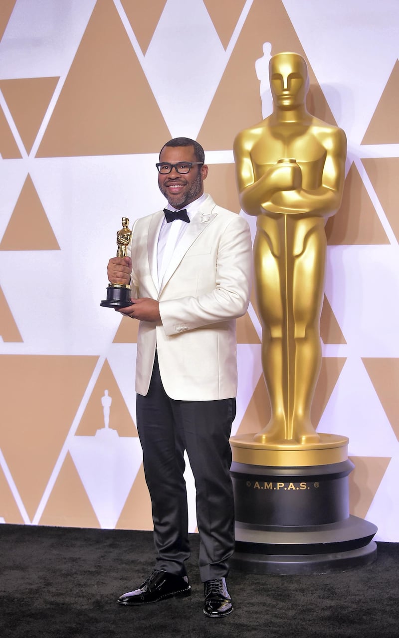 Director Jordan Peele poses in the press room with the Oscar for best original screenplay during the 90th Annual Academy Awards on March 4, 2018, in Hollywood, California. (Photo by FREDERIC J. BROWN / AFP)