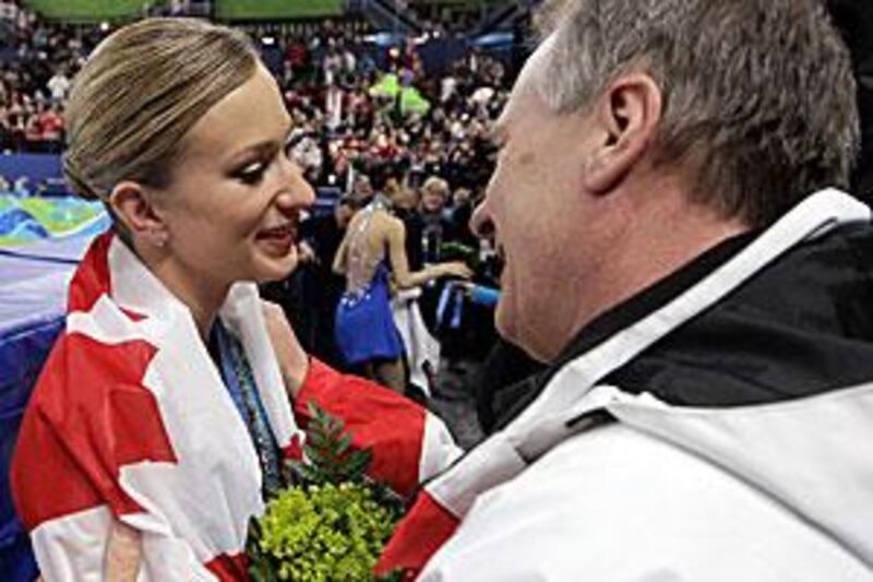 Canada's Joannie Rochette gets a hug from her father, Normand, after winning a bronze.