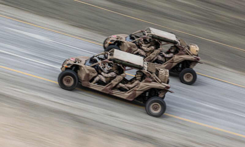 Military buggies race along the desert after being dropped off by a Chinook helicopter. EPA