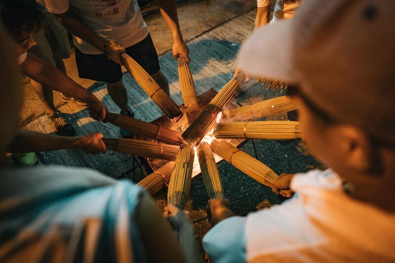 Members of the fire dragon dance team arrange joss sticks onto the dragon during the Tai Hang Fire Dragon Dance Festival.