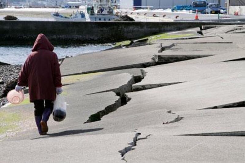 A woman walks on a destroyed dock at a fishing port in Yamada, Iwate Prefecture, northern Japan, last month. Japan will mark the second anniversary of the earthquake and tsunami that hit its north-east on Monday. EPA