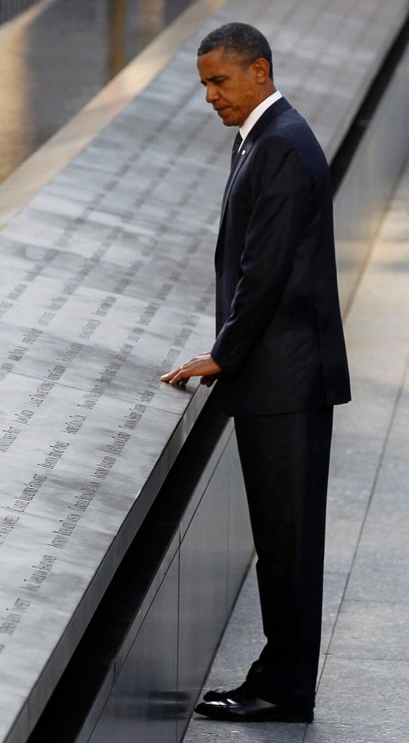 U.S. President Barack Obama touches the names of victims engraved on the side of the north pool of the World Trade Center site during ceremonies marking the 10th anniversary of the 9/11 attacks on the World Trade Center, in New York September 11, 2011.  REUTERS/Larry Downing (UNITED STATES - Tags: ANNIVERSARY DISASTER TPX IMAGES OF THE DAY) *** Local Caption ***  WTC617R_SEPT11-_0911_11.JPG