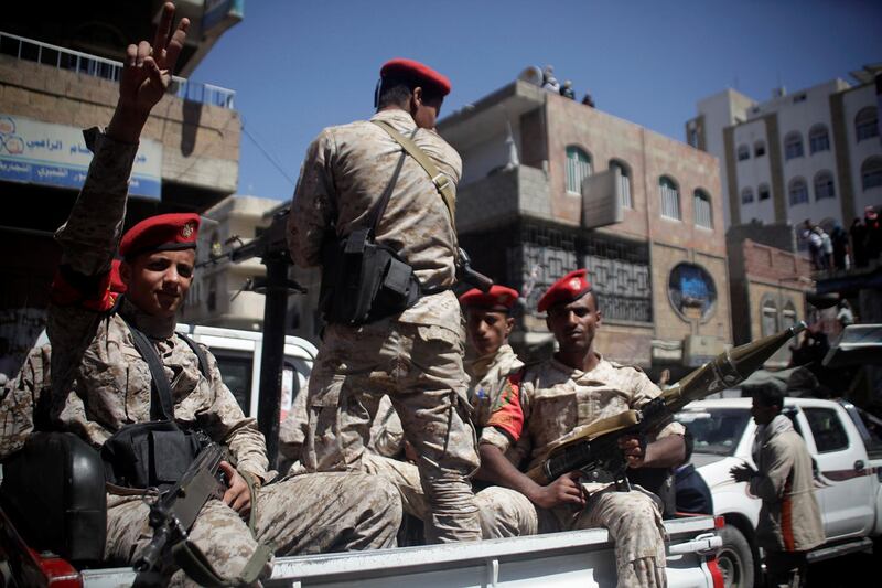 Military police ride on the back or a patrol truck as they secure a road where people held a ceremony commemorating the anniversary of the 2011 uprising that toppled Yemen's former president Ali Abdullah Saleh in Taiz, Yemen February 11, 2018. REUTERS/Anees Mahyoub