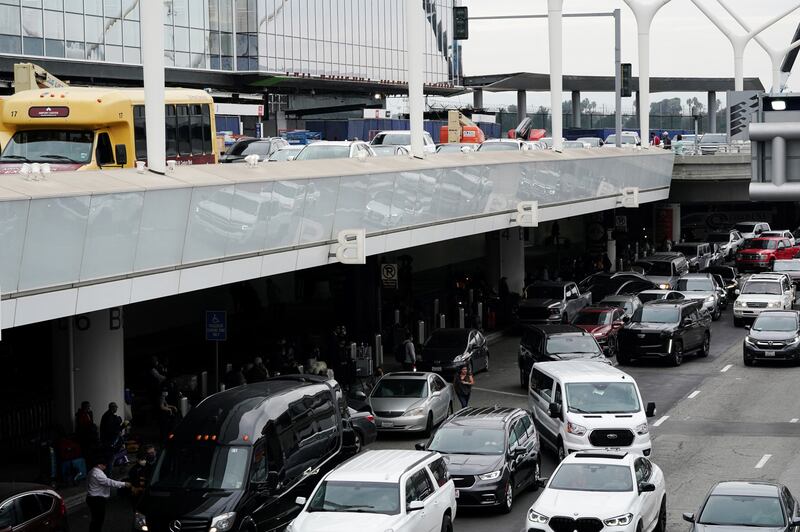 Travellers and vehicles crowd the departures  and arrivals areas outside Tom Bradley International Terminal at Los Angeles International Airport during the holiday season. Reuters