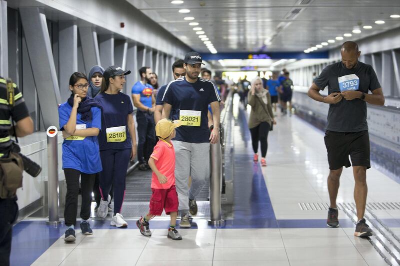 Dubai, United Arab Emirates - Participants of the run arriving at the metro station at the Dubai 30x30 Run at Sheikh Zayed Road.  Leslie Pableo for The National