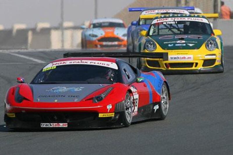 Rob Barff's Ferrari 458, left, put all his worries, and rivals, behind him at Dubai Autodrome to win the UAE GT opener.