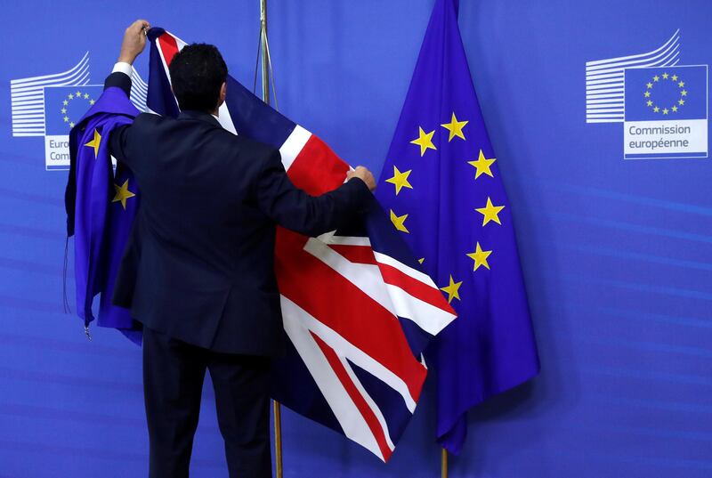 FILE PHOTO: Flags are arranged at the EU Commission headquarters ahead of a first full round of talks on Brexit, Britain's divorce terms from the European Union, in Brussels, Belgium July 17, 2017. REUTERS/Yves Herman/File Photo