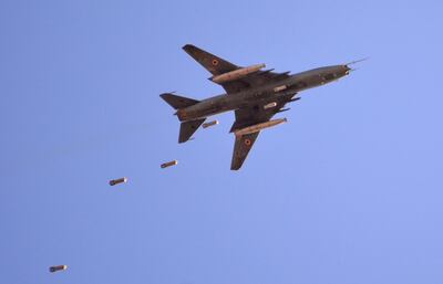 TOPSHOT - A Sukhoi Su-22 Syrian army plane releases bombs over southern Damascus in the area of Yarmuk Palestinian refugee camp on April 24, 2018. 
Forces loyal to Syrian President Bashar al-Assad ramped up their ground operations and bombing raids against the Palestinian refugee camp of Yarmuk in southern Damascus last week fighting the Islamic State group. In 2015, IS overran most of Yarmuk, and other rebels and jihadists, including from Al-Qaeda's former affiliate, agreed to withdraw just a few weeks ago.
 / AFP PHOTO / Rami al SAYED