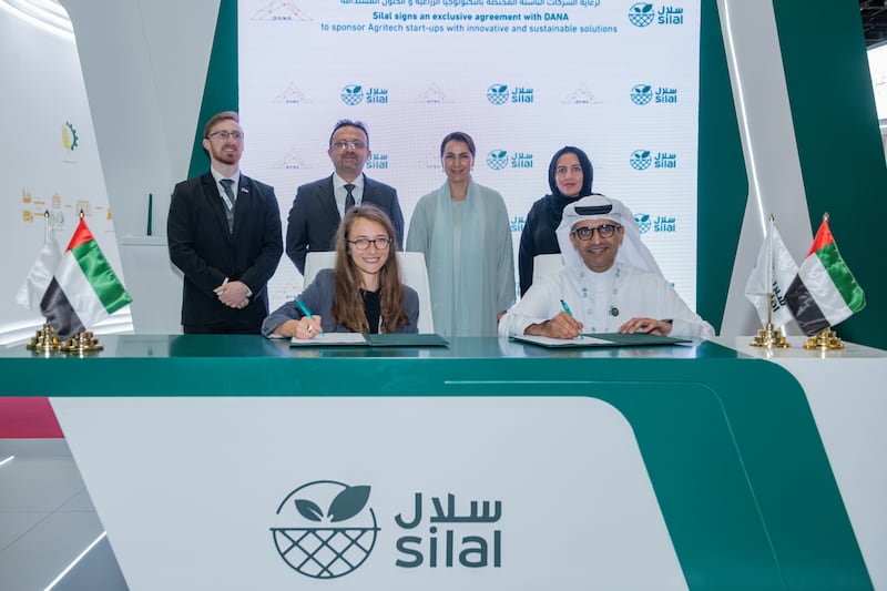 Mariam Almheiri, UAE Minister of Minister of Climate Change and Environment, witnessing the signing ceremony between Katie Wachsberger, co-founder and chief operating officer of Dana Global, and Salmeen Obaid Alameri, chief executive of Silal. Photo: Dana Global