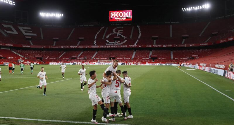 Sevilla players celebrate after Ocampos' goal against Real Betis. EPA