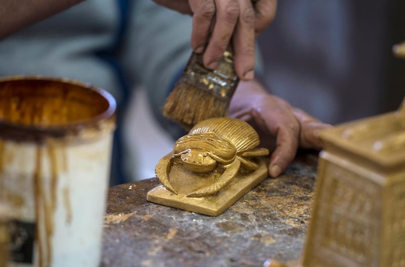 An artist prepares a replica of a scarab at the workshop of the Replica Production Unit located at Salah Al Din Citadel in Cairo, Egypt. EPA