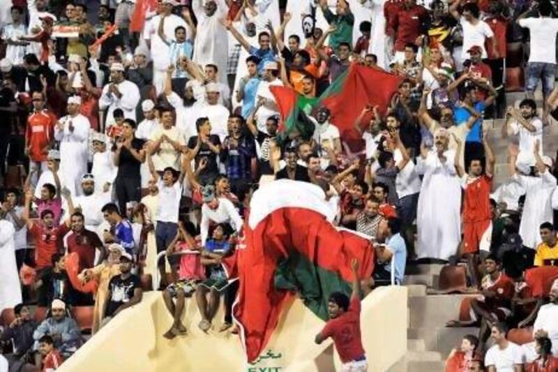 Oman fans cheer their team during the 2014 World Cup qualifying match against Jordan in Muscat.