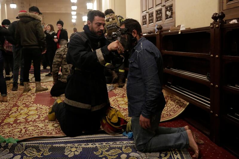 An anti-government protester receives treatment after confrontation with Lebanese riot police inside the Mohammad al-Amin Mosque in Beirut. AP Photo