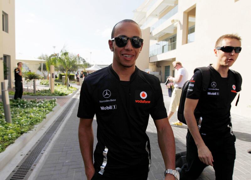McLaren Formula One driver Lewis Hamilton of Britain (L) arrives at the Yas Marina circuit ahead of the Abu Dhabi F1 Grand Prix November 10, 2011. REUTERS/Jumana El Heloueh (UNITED ARAB EMIRATES - Tags: SPORT MOTORSPORT) *** Local Caption ***  ABD09_MOTOR-RACING-_1110_11.JPG