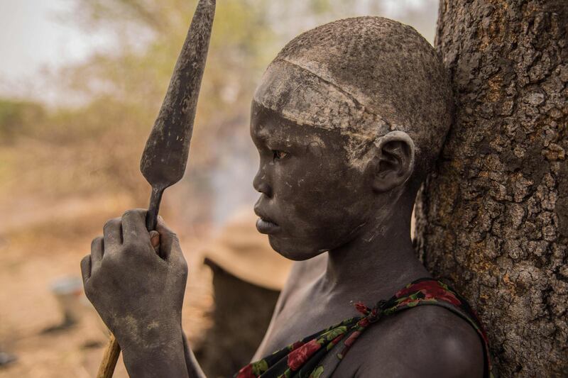 A Sudanese boy holds his spear.