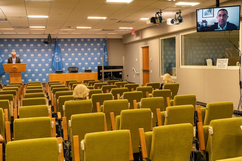 Stephane Dujarric de la Riviere, left, spokesperson for the United Nations Secretary-General António Guterres, takes a question from a reporter, right, via video link as others observe social distancing during the noon briefing, on Monday, September 21, 2020 at United Nations headquarters. AP Photo