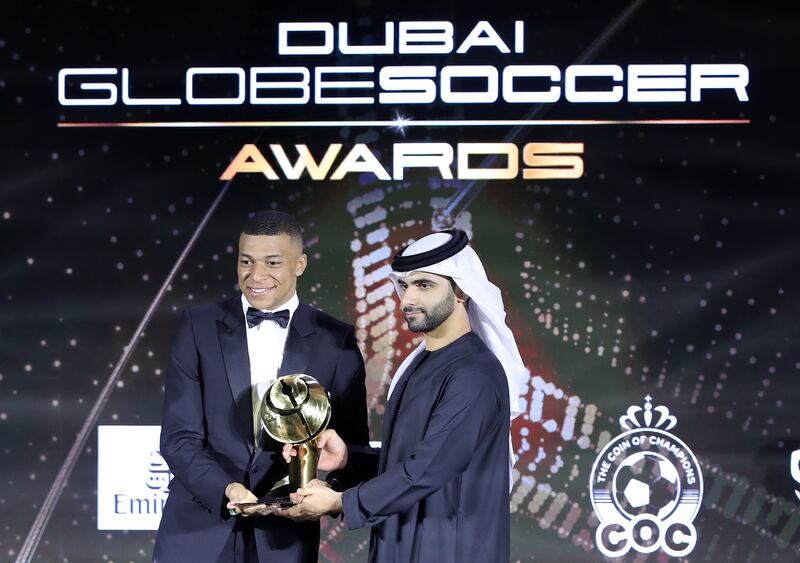 Sheikh Mansoor bin Mohammed gives PSG striker Kylian Mbappe the best men's player of the year award at the Dubai Globe Soccer Awards at the Armani Hotel on Monday. All images Chris Whiteoak/ The National