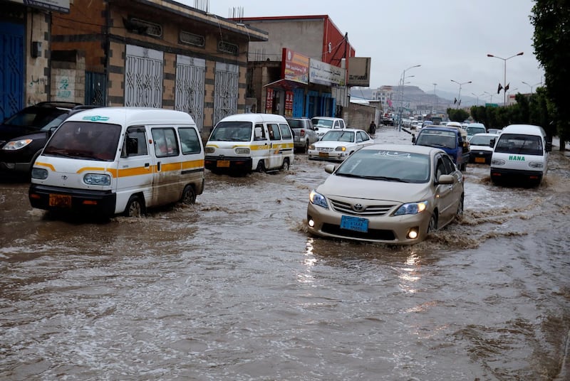 Vehicles drive through a flooded street following heavy rains in Sana'a, Yemen.  EPA