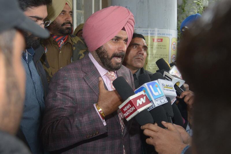 Indian cricketer-turned-politician, former member of parliament and current Congress Party candidate for the Punjab Legislative Assembly, Navjot Singh Sidhu (C) speaks to media after casting his vote in the Punjab Legislative Assembly and Amritsar Lok Sabha elections Amritsar on February 4, 2017. - Millions of Indians began voting February 4 in regional elections seen as the first major test of Prime Minister Narendra Modi's party after his controversial move to ban all high-value notes last year. (Photo by NARINDER NANU / AFP)