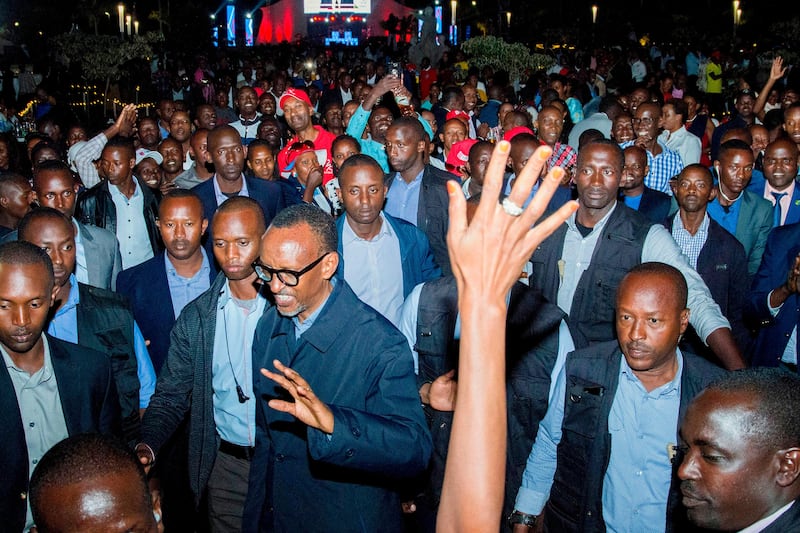 TOPSHOT - Rwandan President Paul Kagame (C) celebrates his reelection with supporters in Kigali on August 5, 2017 at the Rwandan Patriotic Front headquarters. 
Rwandan President Paul Kagame sailed to a third term in office with a tally hovering around a whopping 98 percent of votes, partial results showed Saturday. There had been little doubt that the 59-year-old would return to the helm of the east African nation which he has ruled with an iron fist since the end of the 1994 genocide. / AFP PHOTO / CYRIL NDEGEYA