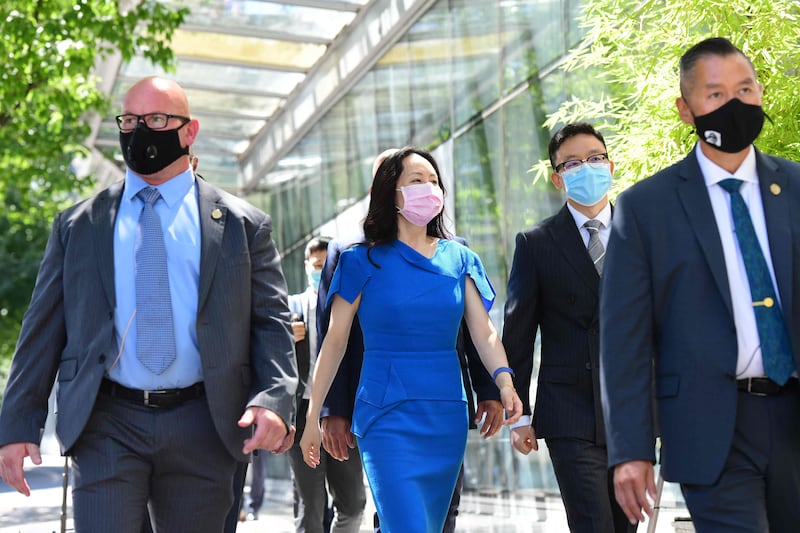 Huawei's chief financial officer, Meng Wanzhou, arrives at the British Columbia Supreme Court with her security detail for the afternoon session of her extradition hearing in Vancouver, Canada. AFP