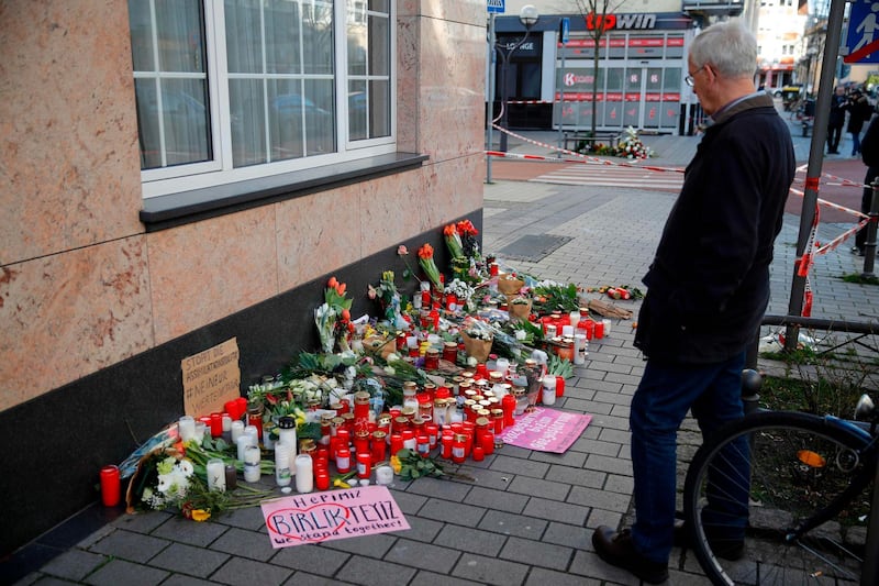 A man stands in front of a makeshift memorial for the victims of the Hanau shooting in Hanau near Frankfurt am Main, western Germany. Thousands of people took part in vigils across Germany on February 20, 2020, after a gunman with apparent far-right beliefs killed nine people at a shisha bar and a cafe in the city of Hanau. The suspect, a 43-year-old German, was found dead at his home after the rampage along with his 72-year-old mother in what appeared to be a murder-suicide.  AFP