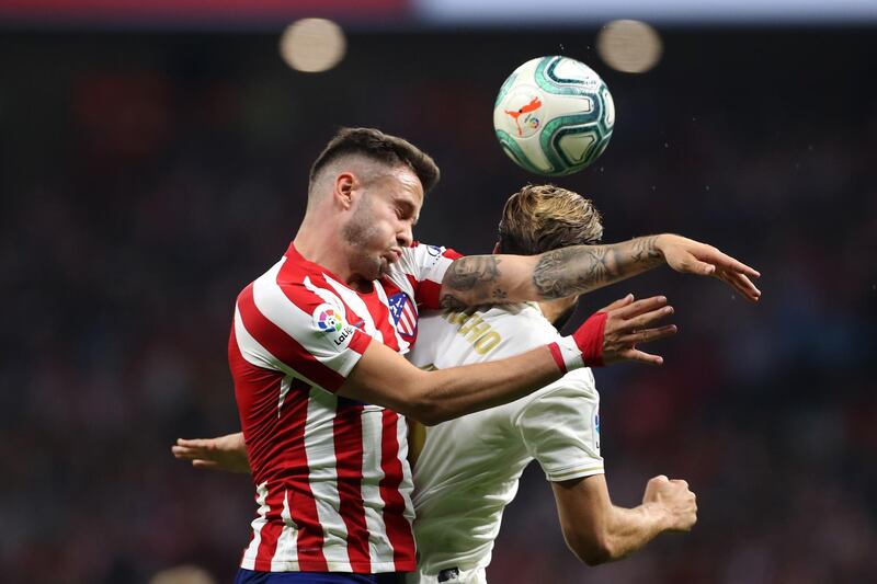 MADRID, SPAIN - SEPTEMBER 28:  Saul of Atletico Madrid battles for the ball with Nacho of Real Madrid during the Liga match between Club Atletico de Madrid and Real Madrid CF at Wanda Metropolitano on September 28, 2019 in Madrid, Spain. (Photo by Angel Martinez/Getty Images)