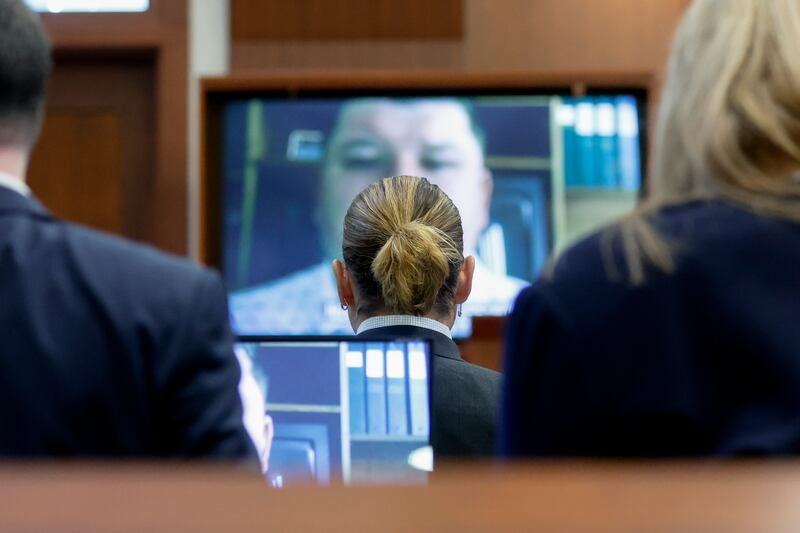 Depp watches the recorded testimony of Los Angeles Police Department officer William Gatlin. AP