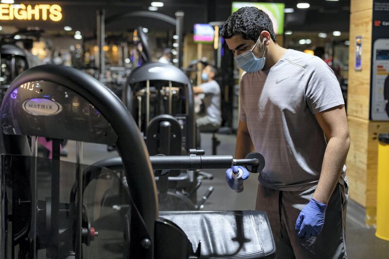 Dubai, United Arab Emirates - Reporter: Kelly Clark: News. A man cleans the equipment after he uses it at GymNation in Al Quoz as gyms across Dubai start to open. Wednesday, May 27th, 2020. Dubai. Chris Whiteoak / The National