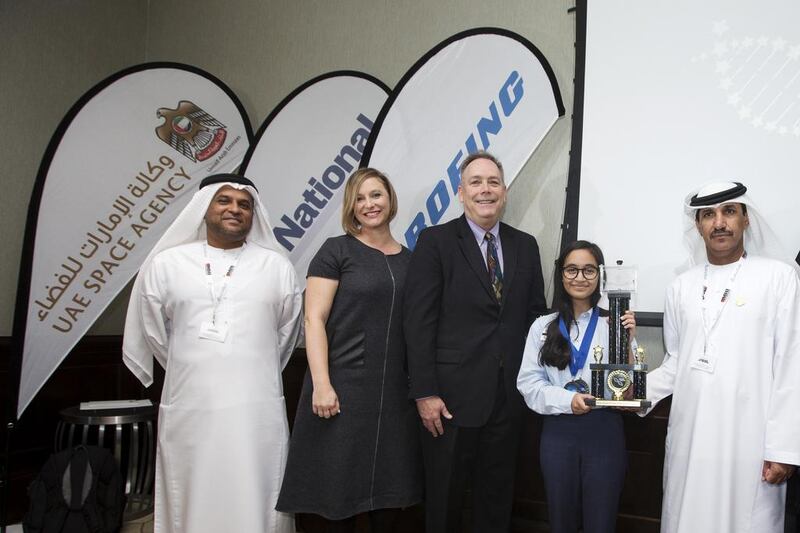 L-R: Khaled Al Hashmi, director of space missions for the UAE Space Agency, Laura Koot, managing editor of The National, Kevin Foley, global sales and marketing for space exploration for Boeing, and Dr Mohammed Al Ahbabi, director general of the UAE Space Agency, present Alia Al Mansoori with her award for winning the Genes in Space competition. Christopher Pike / The National