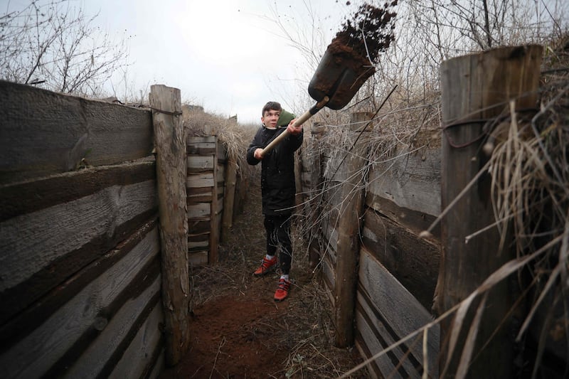 A Ukrainian teenager digs trenches for soldiers serving on their country's eastern front and facing off with Russian-backed separatists, near Chervone. AFP