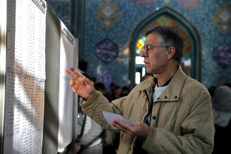 A voter fills out his ballot in the parliamentary elections at a polling station in Tehran, Iran. Iranians began voting for a new parliament on Friday, with turnout seen as a key measure of support for Iran's leadership as sanctions weigh on the economy and isolate the country diplomatically. AP