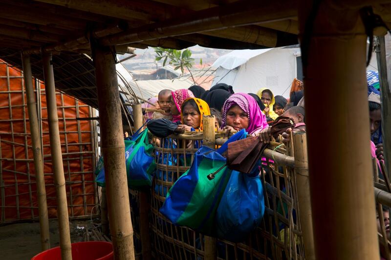 Rohingya Muslims women wait outside a food distribution center at Balukhali refugee camp 50 kilometres (32 miles) from, Cox's Bazar, Bangladesh, Monday, Jan. 15, 2018. Myanmar officials say a camp to house Rohingya Muslim and Hindu refugees who return from Bangladesh will be ready by its promised deadline next week. Myanmar and Bangladesh are discussing the logistics of how many Rohingya will be allowed into Myanmar and how they will be scrutinized to be placed in the camps. Hundreds of thousands of Rohingya have fled violence that has been described as ethnic cleansing. Observers doubt Rohingya will return to Myanmar willing unless their safety is guaranteed.(AP Photo/Manish Swarup)