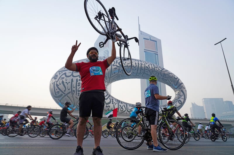 A cyclist poses for a photograph in front of the museum in November. AP Photo / Jon Gambrell