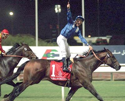 Jockey Richard Hills rides "Almutawakel" to victory in the world's richest race, the five-million dollar Dubai World Cup, 28 March 1999. The three-million dollar first prize was clinched in a track record time of 2min 00.65sec. (Photo by JORGE FERRARI / AFP)