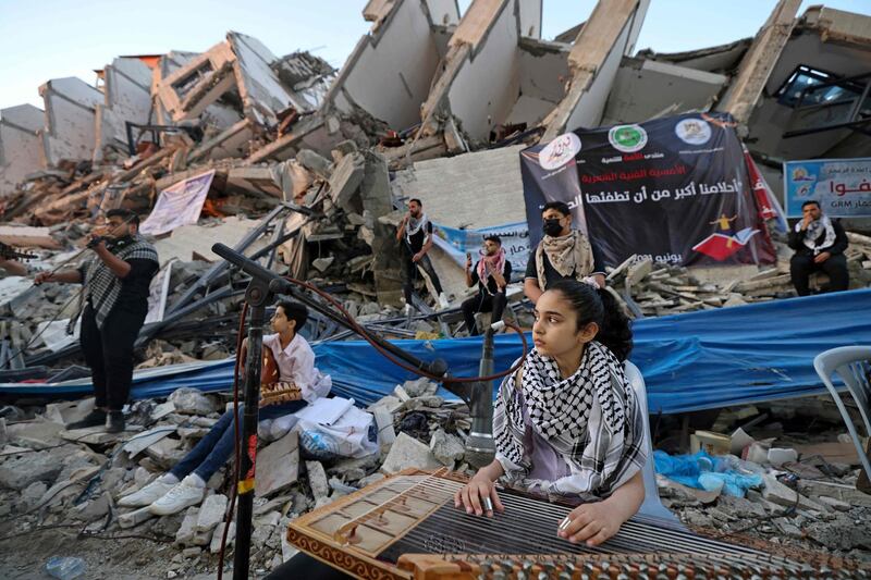For musicians, all the world's a stage, even in the rubble of a building in Gaza City destroyed by an Israeli air strike in the recent conflict with Hamas. AFP