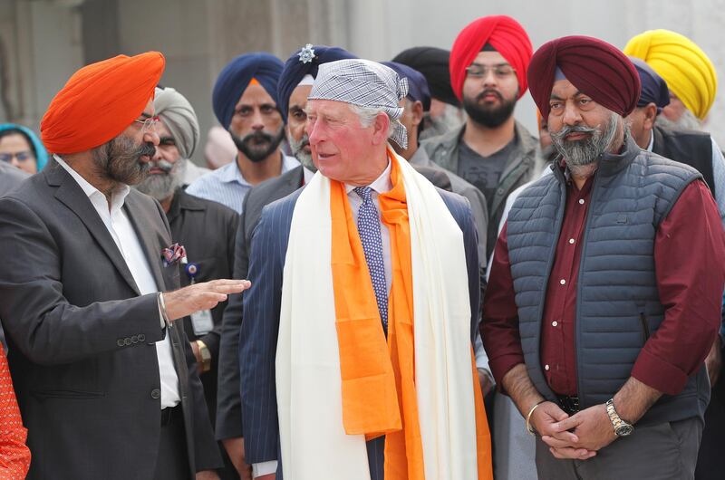 Prince Charles talks to people during his visit to a Gurudwara. Reuters