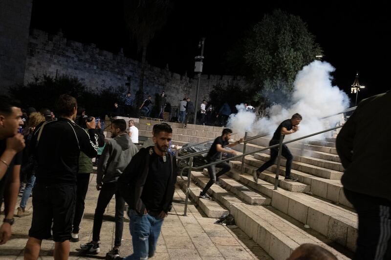 Palestinians react as Israeli police fire stun grenades at the Damascus Gate to the Old City of Jerusalem, following clashes at the Al Aqsa Mosque compound. AP Photo