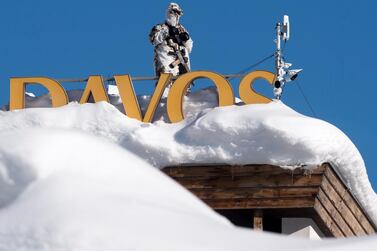 A member of the Swiss special police forces stands on the roof of the Kongress Hotel next to the Congress Center the first day of the World Economic Forum in Davos. EPA