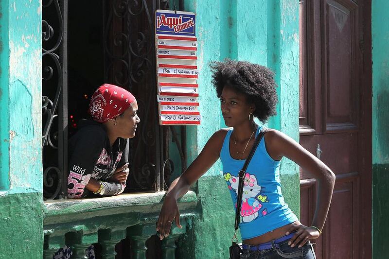 Two women chat at a window of a cafe in Havana. The Cuban private sector is confident that US measures to begin normalising relations with the communist island would improve business activity. Alejandro Ernesto / EPA