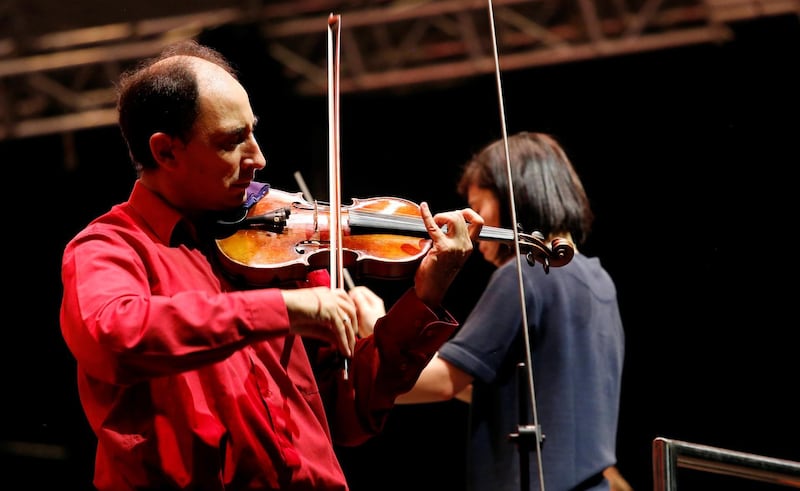 Violinist Carmine Laurie, the Orchestra's leader of the London Symphony Orchestra performs during an outdoor classic concert in Hanoi, Vietnam October 5, 2018. REUTERS/Kham