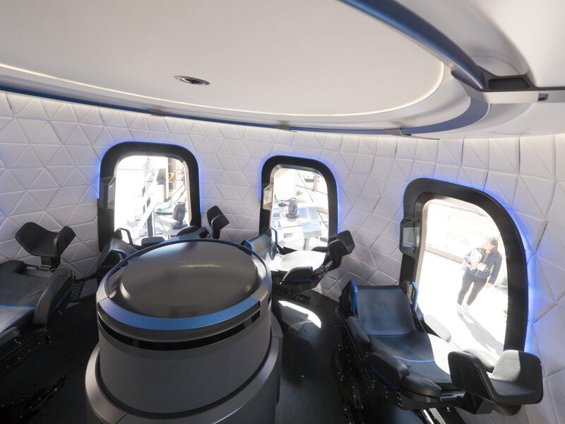 The interior the high fidelity crew capsule mock up of the Blue Origin LLC New Shepard system sits on display during the Space Symposium in Colorado Springs, Colorado, U.S., on Wednesday, April 5, 2017. Jeff Bezos, chief executive officer of Amazon.com Inc. and founder of Blue Origin, has been reinvesting money he made at Amazon since he started his space exploration company more than a decade ago, and has plans to launch paying tourists into space within two years. Photographer: Matthew Staver/Bloomberg