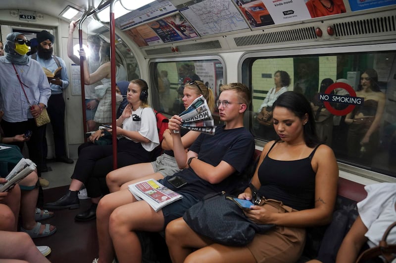 Passengers feel the heat on the London Underground. The operator advised its customers not to use the metro during the worst of the heatwave. AP