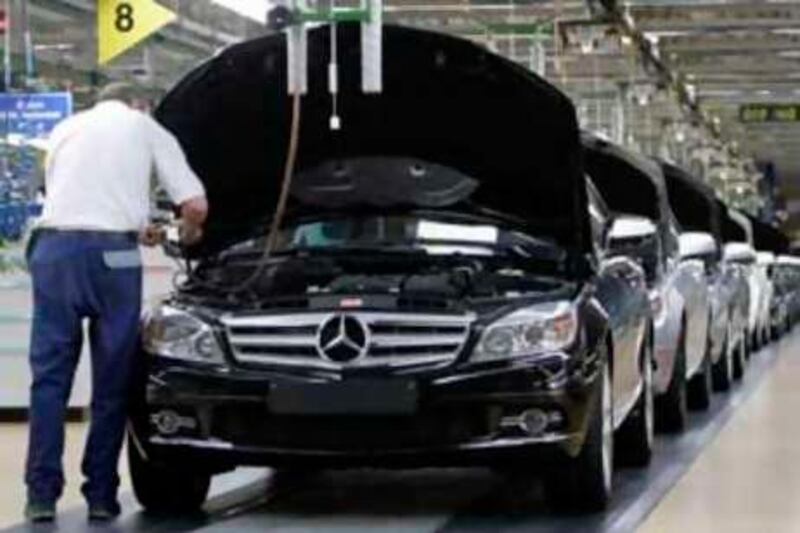** FILE ** In this Jan. 25, 2008 file picture, an employee of German car producer Mercedes-Benz checks a Mercedes C-class as it rolls off the production line  in the plant in Sindelfingen near Stuttgart, Germany. Daimler AG said Thursday Nov. 27, 2008 it is considering cutting working hours at some of its car production plants in Germany as the economic gloom pushes down sales. The company said it may scale back hours at Mercedes-Benz car manufacturing facilities in Sindelfingen, Berlin, Bremen and Dusseldorf.  (AP Photo/Thomas Kienzle) *** Local Caption ***  FRA120_Germany_Daimler.jpg
