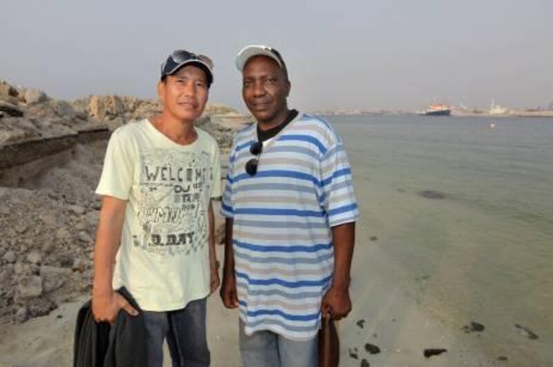 United Arab Emirates - Ajman - Sep 29 - 2010 : Sailors Nelson Aguilar (left) and Juma Mohammed Mkumba, pose for a portrait near the Ajman port. These two sailors who have been trapped in Ajman port for two years. ( Jaime Puebla / The National )