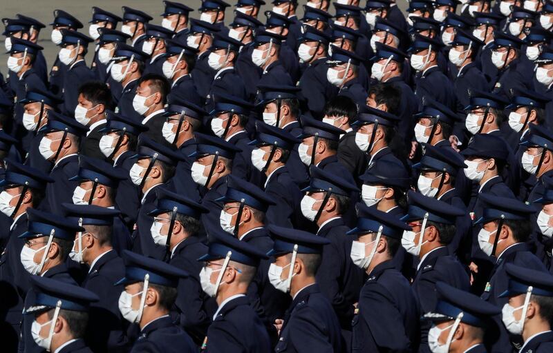 Japan's Air Self-Defense Force personnel stand while being reviewed by Japanese Prime Prime Minister Yoshihide Suga at Iruma Air Base in Sayama, northwest of Tokyo. Pool Photo via AP